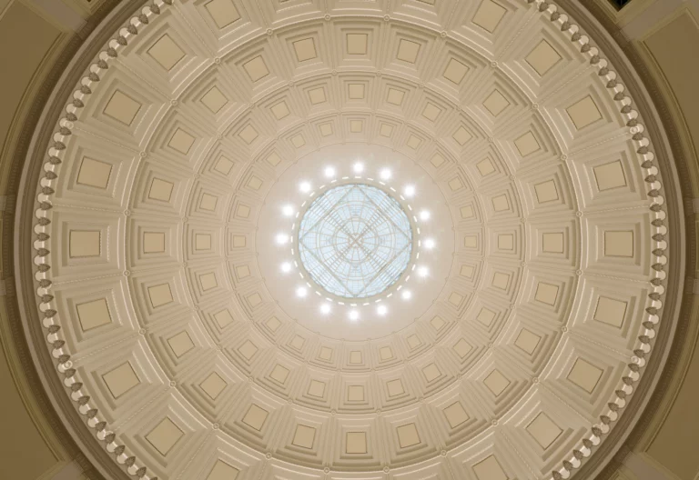 Below view shot of the Barker Library dome at MIT with intricate geometric patterns and a central skylight.