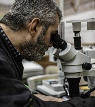 John Canning Co.'s David Riccio conducting a paint analysis through a microscope.